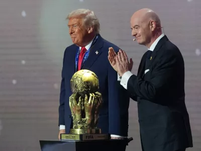 President Donald Trump receives the FIFA Peace Prize from FIFA President Gianni Infantino during the draw for the 2026 soccer World Cup at the Kennedy Center in Washington, Friday, Dec. 5, 2025. (AP Photo/Jacquelyn Martin)