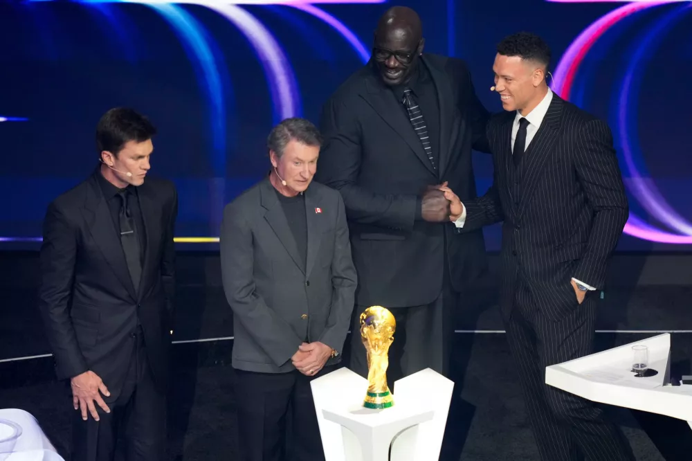 From left; former NFL player Tom Brady, former NHL player Wayne Gretzky, former NBA player Shaquille O'Neal, and New York Yankees' Aaron Judge participate in the draw for the 2026 soccer World Cup at the Kennedy Center in Washington, Friday, Dec. 5, 2025. (AP Photo/Alex Brandon)