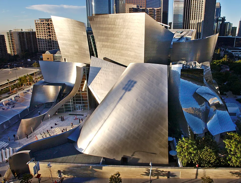 FILE - Early morning sun rays illuminate the Walt Disney Concert Hall designed by Frank Gehry, in downtown Los Angeles, Nov. 19, 2009. (AP Photo/Nick Ut, File)