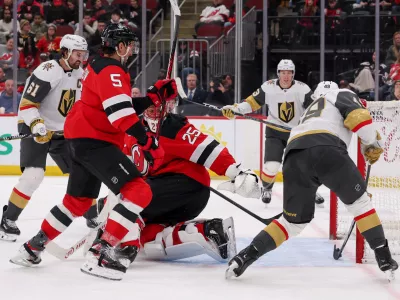 Dec 5, 2025; Newark, New Jersey, USA; Vegas Golden Knights left wing Ivan Barbashev (49) scores a goal on New Jersey Devils goaltender Jacob Markstrom (25) during the third period at Prudential Center. Mandatory Credit: Ed Mulholland-Imagn Images