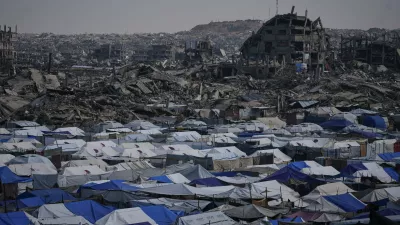 Tents sheltering displaced Palestinians stand amid the destruction left by the Israeli air and ground offensive in Gaza City Friday, Dec. 5, 2025. (AP Photo/Abdel Kareem Hana)