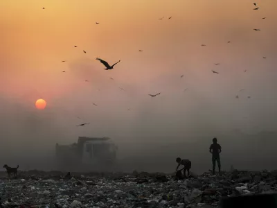 ﻿A thick blanket of smoke is seen against the setting sun as young ragpickers search for reusable material at a garbage dump in New Delhi, India, Friday, Oct. 17, 2014. India launched the Air Quality Index Friday to measure air quality across the nation that is home to some of the most polluted cities in the world. It will measure eight major pollutants that impact respiratory health in cities with populations exceeding 1 million in the next five years and then gradually the rest of the country, Environment Minister Prakash told reporters. The World Health Organization said earlier this year that the Indian capital had the worst air quality in the world, surpassing Beijing, a statement that New Delhi has vehemently disputed. (AP Photo/Altaf Qadri)
