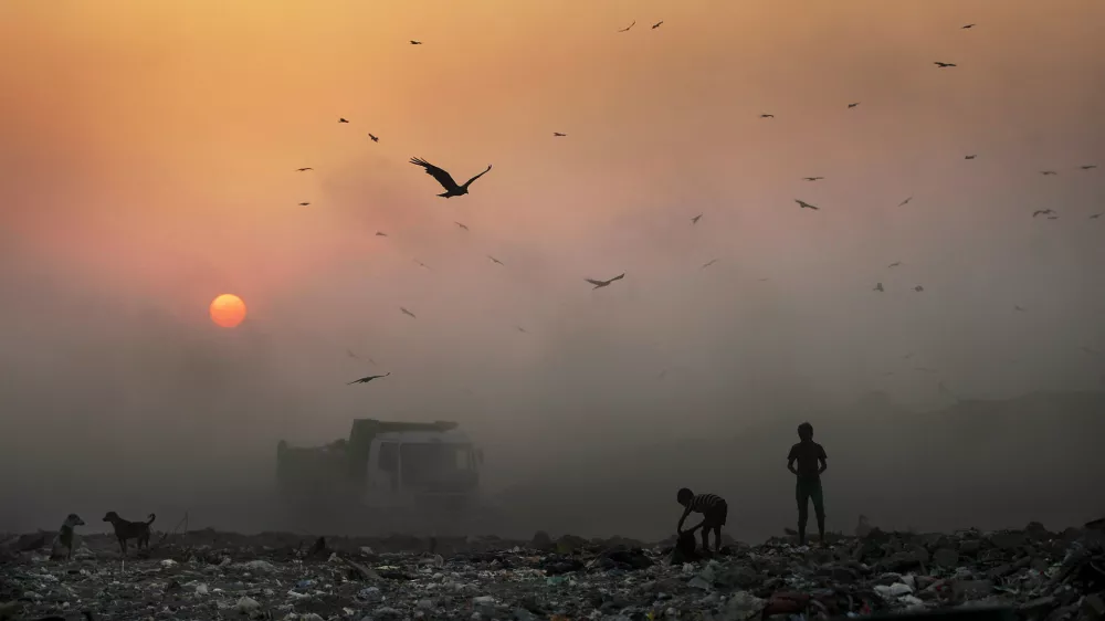 ﻿A thick blanket of smoke is seen against the setting sun as young ragpickers search for reusable material at a garbage dump in New Delhi, India, Friday, Oct. 17, 2014. India launched the Air Quality Index Friday to measure air quality across the nation that is home to some of the most polluted cities in the world. It will measure eight major pollutants that impact respiratory health in cities with populations exceeding 1 million in the next five years and then gradually the rest of the country, Environment Minister Prakash told reporters. The World Health Organization said earlier this year that the Indian capital had the worst air quality in the world, surpassing Beijing, a statement that New Delhi has vehemently disputed. (AP Photo/Altaf Qadri)