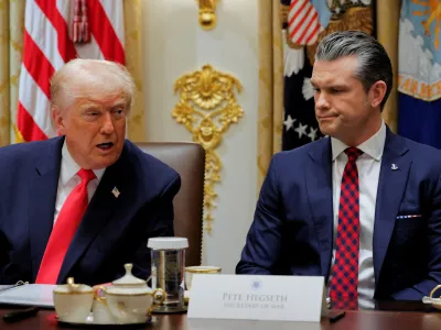 U.S. Secretary of Defense Pete Hegseth reacts as U.S. President Donald Trump speaks during a cabinet meeting, at the White House in Washington, D.C., U.S., December 2, 2025. REUTERS/Brian Snyder  TPX IMAGES OF THE DAY