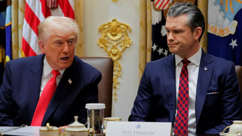 U.S. Secretary of Defense Pete Hegseth reacts as U.S. President Donald Trump speaks during a cabinet meeting, at the White House in Washington, D.C., U.S., December 2, 2025. REUTERS/Brian Snyder  TPX IMAGES OF THE DAY