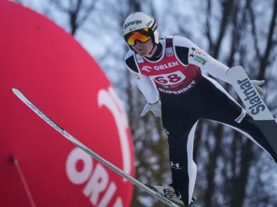Domen Prevc of Slovenia soars through the air during his first round jump of the ski jumping Men's Large Hill HS134 event at the FIS Ski Jumping World Cup in Wisla, Poland, Sunday, Dec. 7, 2025. (AP Photo/Czarek Sokolowski)