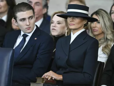 Barron Trump and first lady Melania Trump listen as President Donald Trump delivers remarks after being sworn in during the 60th Presidential Inauguration in the Rotunda of the U.S. Capitol in Washington, Monday, Jan. 20, 2025. (Saul Loeb/Pool photo via AP)