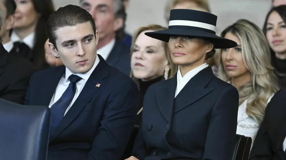 Barron Trump and first lady Melania Trump listen as President Donald Trump delivers remarks after being sworn in during the 60th Presidential Inauguration in the Rotunda of the U.S. Capitol in Washington, Monday, Jan. 20, 2025. (Saul Loeb/Pool photo via AP)