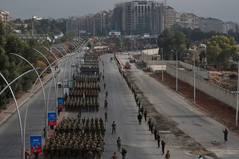Members of the new Syrian army line up in formation during a parade marking the first anniversary of the ousting of former President Bashar Assad, in Damascus, Syria, Monday, Dec. 8, 2025. (AP Photo/Omar Sanadiki)