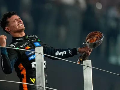 McLaren driver Lando Norris of Britain celebrates after becoming a world champion after the Formula One Abu Dhabi Grand Prix at the Yas Marina Circuit in Abu Dhabi, UAE, Sunday, Dec. 7, 2025. (AP Photo/Fatima Shbair)