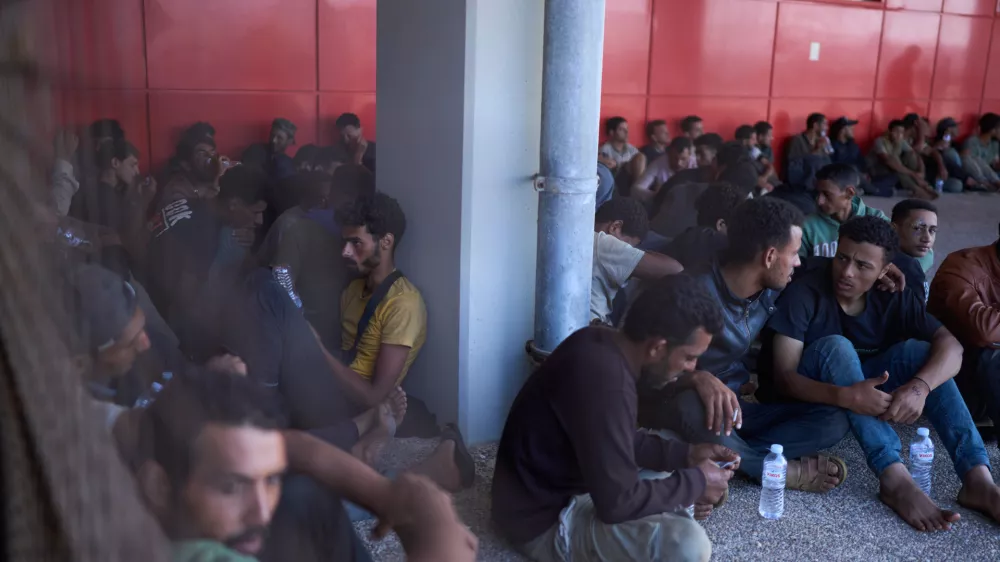 FILE - Migrants rescued south of Crete wait to be registered on their arrival at the the port of Lavrio, Greece, on Thursday, July 10, 2025. (AP Photo/Petros Giannakouris, file)