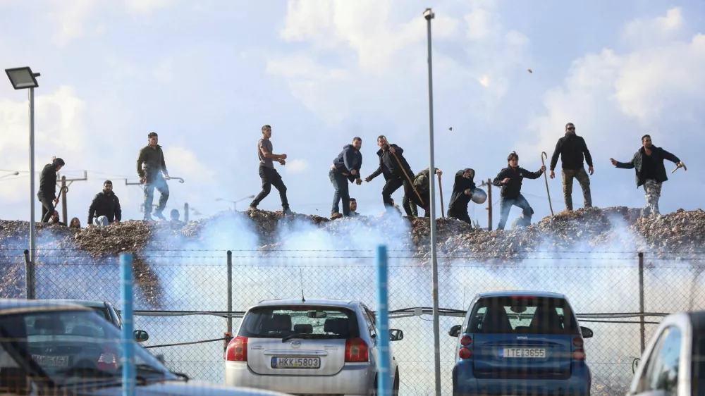 Greek farmers protesting over the delayed payment of European Union subsidies hurl stones amid tear gas at the Heraklion International Airport, in Heraklion, Crete island, Greece, December 8, 2025. REUTERS/Stefanos Rapanis   TPX IMAGES OF THE DAY