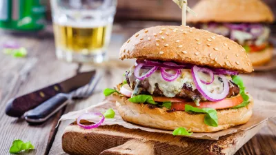 ﻿homemade burger with beef cutlet, apple, lettuce, onion and blue cheese on wooden table