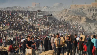 FILE - People carry sacks and boxes of food and humanitarian aid that was unloaded from a World Food Program convoy that had been heading to Gaza City in the northern Gaza Strip, June 16, 2025. (AP Photo/Jehad Alshrafi, File)