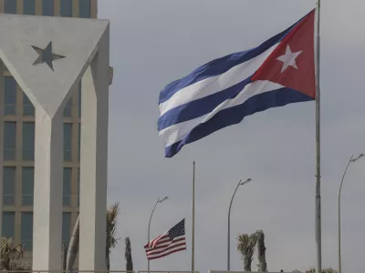 Cuban and American flags fly in the wind outside the American embassy in Havana, Cuba, Tuesday, Jan.14, 2025. (AP Photo/Ariel Ley)