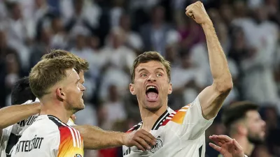 FILE - Germany's Thomas Mueller, right, celebrates during the Group A match between Germany and Scotland at the Euro 2024 soccer tournament in Munich, Germany, Friday, June 14, 2024. Germany forward Thomas Müller has announced his retirement from international soccer after a 14-year career that included the 2014 World Cup title. (Christian Charisius/dpa via AP, File)