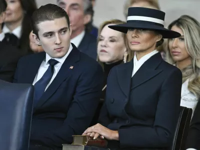 Barron Trump and first lady Melania Trump listen as President Donald Trump delivers remarks after being sworn in during the 60th Presidential Inauguration in the Rotunda of the U.S. Capitol in Washington, Monday, Jan. 20, 2025. (Saul Loeb/Pool photo via AP)