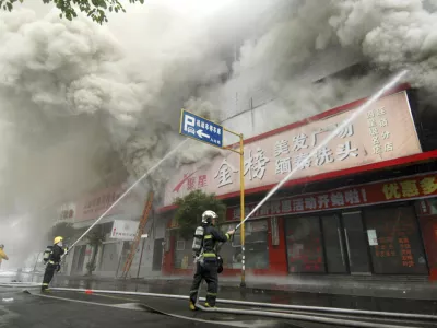 Firemen put out a fire at a building in Wenzhou, Zhejiang province, December 12, 2007. The fire in a ground-floor flower shop in east China spread into a block of apartments above on Wednesday, killing at least 19 people, media said. REUTERS/China Daily (CHINA) CHINA OUT