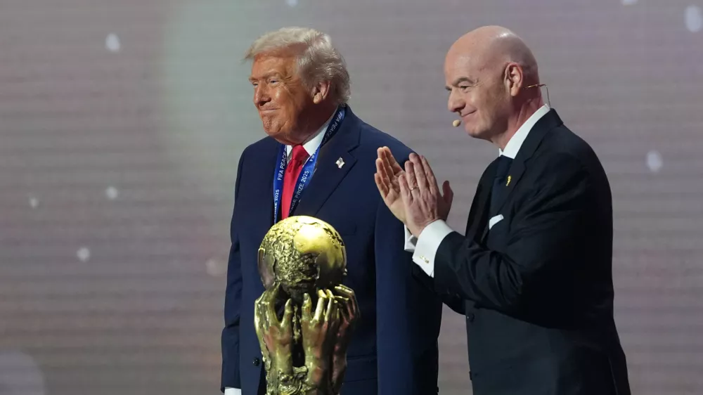 President Donald Trump receives the FIFA Peace Prize from FIFA President Gianni Infantino during the draw for the 2026 soccer World Cup at the Kennedy Center in Washington, Friday, Dec. 5, 2025. (AP Photo/Jacquelyn Martin)