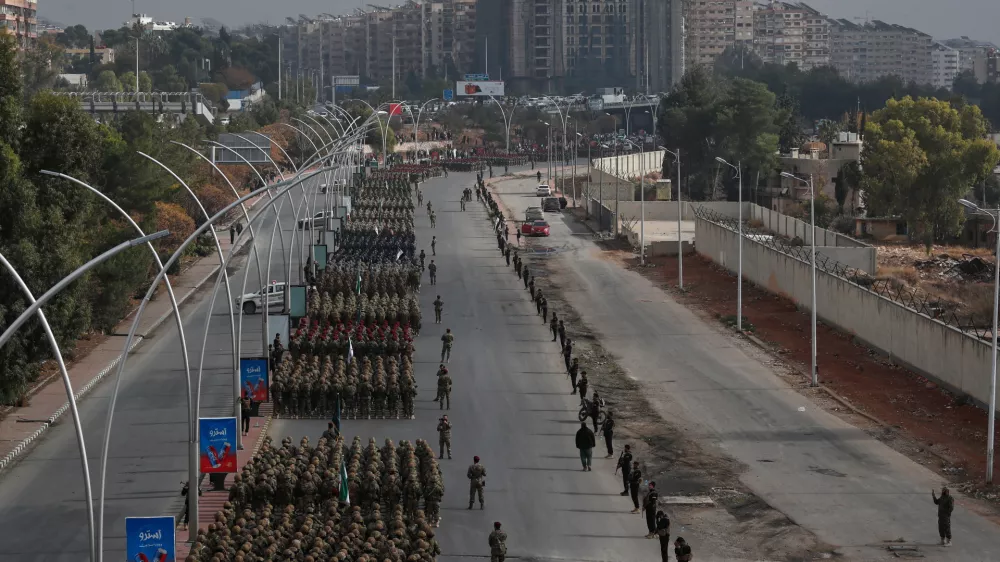Members of the new Syrian army line up in formation during a parade marking the first anniversary of the ousting of former President Bashar Assad, in Damascus, Syria, Monday, Dec. 8, 2025. (AP Photo/Omar Sanadiki)