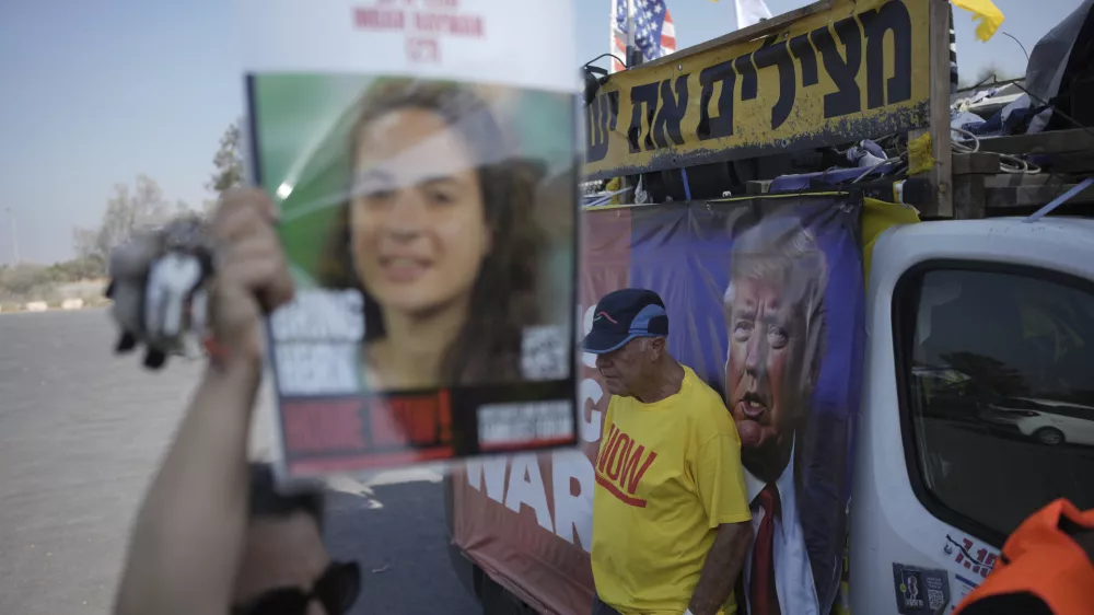 People take part in a protest demanding an end to the war and the immediate release of hostages held by Hamas in the Gaza Strip, at the site of the October 7, 2023 Hamas attack on the Nova music festival near Kibbutz Reim, southern Israel, Wednesday, July 2, 2025. (AP Photo/Ohad Zwigenberg)