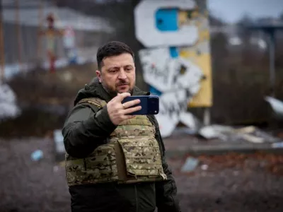 Ukraine's President Volodymyr Zelenskiy self-records a video in front of a sign that reads 'Kupiansk', amid Russia's attack on Ukraine, in the frontline town of Kupiansk, Kharkiv region, Ukraine December 12, 2025. Ukrainian Presidential Press Service/Handout via REUTERS ATTENTION EDITORS - THIS IMAGE HAS BEEN SUPPLIED BY A THIRD PARTY.