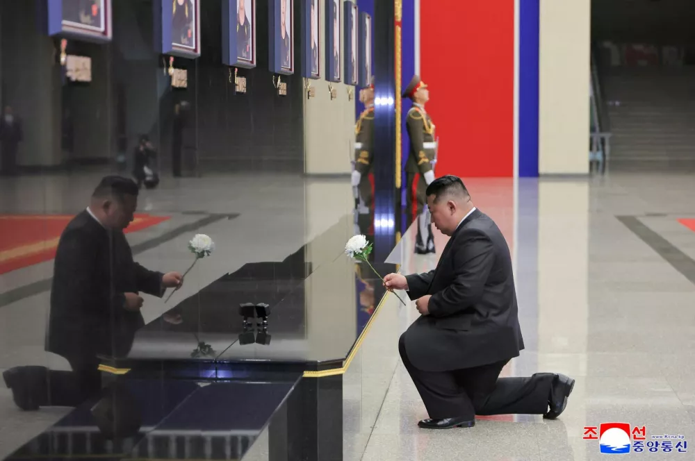 North Korean leader Kim Jong Un kneels while placing a white flower at a memorial wall during a welcoming ceremony for members of the 528th Engineer Regiment after they returned from an overseas mission, at the April 25 Cultural and Tourism Center in Pyongyang, North Korea, December 12, 2025, in this picture released by North Korea's official Korean Central News Agency on December 13, 2025. REUTERS/KCNA  KCNA via REUTERS  ATTENTION EDITORS - THIS IMAGE WAS PROVIDED BY A THIRD PARTY. REUTERS IS UNABLE TO INDEPENDENTLY VERIFY THIS IMAGE. NO THIRD PARTY SALES. SOUTH KOREA OUT. NO COMMERCIAL OR EDITORIAL SALES IN SOUTH KOREA.
