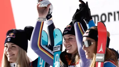 Germany's Emma Aicher, center, winner of an alpine ski, women's World Cup downhill, poses on the podium with second placed United States' Lindsey Vonn, left, and third placed Italy's Sofia Goggia in St. Moritz, Switzerland, Saturday Dec. 13, 2025. (AP Photo/Gabriele Facciotti)