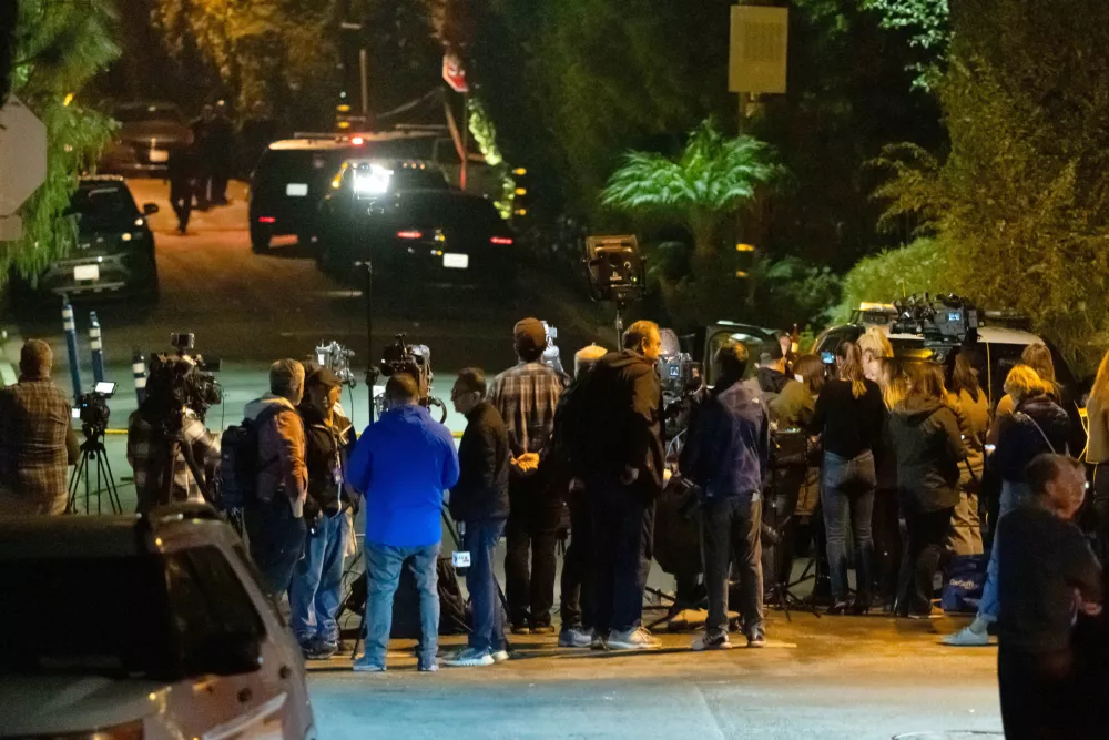 News crews stage near Rob Reiner's residence Sunday, Dec. 14, 2025, in the Brentwood section of Los Angeles. (AP Photo/Ethan Swope)