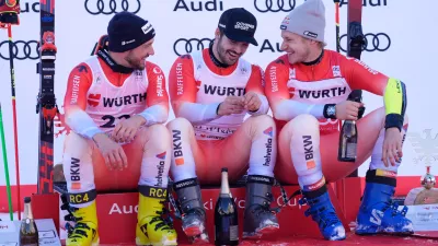 Switzerland's Loic Meillard, center, winner of an alpine ski, men's World Cup giant slalom event, sits by fellow-countrymen second placed Luca Aerni, left, and third placed Marco Odermatt, in Val d'Isere, France, Saturday Dec. 13, 2025. (AP Photo/Giovanni Auletta) (AP Photo/Giovanni Auletta)