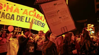 FILE PHOTO: A demonstrator holds a house-shaped sign that reads "from touristic flat to temporary rent to Airbnb" during a protest to demand lower housing rental prices and better living conditions, in Barcelona, Spain, November 23, 2024. REUTERS/Bruna Casas/File Photo