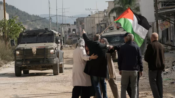 Displaced Palestinians gather during a protest calling to return to their houses in the Nur Shams refugee camp, in the West Bank city of Tulkarem, Monday, Dec. 15, 2025. (AP Photo/Majdi Mohammed)
