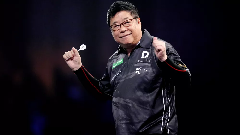 13 December 2025, United Kingdom, London: Singapore's Paul Lim celebrates during his match against Jeffrey de Graaf on day three of the Paddy Power World Darts Championship at the Alexandra Palace. Photo: John Walton/PA Wire/dpa