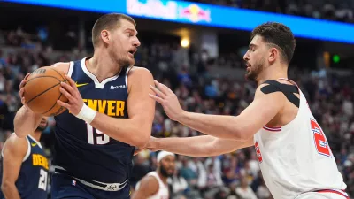 Denver Nuggets center Nikola Jokic pulls in a rebound as Houston Rockets center Alperen Sengun defends in the second half of an NBA basketball game Monday, Dec. 15, 2025, in Denver. (AP Photo/David Zalubowski)