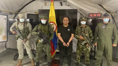 In this photo released by the Colombian presidential press office, one of the countryâ€™s most wanted drug traffickers, Dairo Antonio Usuga, alias â€śOtoniel,â€ť leader of the violent Clan del Golfo cartel, is presented to the media at a military base in Necocli, Colombia, Saturday, Oct. 23, 2021. (Colombian presidential press office via AP)