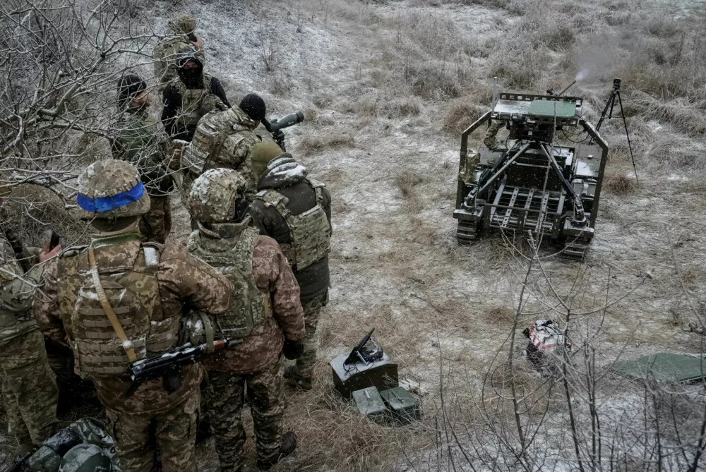 Servicemen of the 66th Separate Mechanized Brigade of the Ukrainian Armed Forces test an unmanned ground vehicle with Browning M2 machine gun installed on it, amid Russia's attack on Ukraine, in Kharkiv region, Ukraine, December 15, 2025. REUTERS/Sofia Gatilova