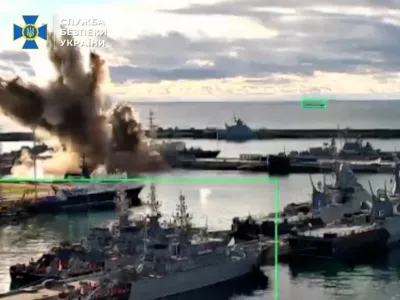 Footage released by the Security Service of Ukraine shows what it says is a strike on a Russian submarine at a port facility, in Novorossiysk, Krasnodar Region, Russia, in this screengrab from video released on December 15, 2025.  Security Service Of Ukraine/Handout via REUTERS  THIS IMAGE HAS BEEN SUPPLIED BY A THIRD PARTY. GRAPHIC OVERLAYS FROM SOURCE. BEST QUALITY AVAILABLE. Verification: - Port layout and piers matched satellite imagery. - Date could not be verified independently.