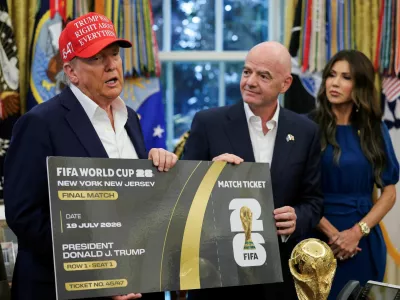 FILE PHOTO: U.S. President Donald Trump and FIFA president Gianni Infantino hold a 2026 FIFA World Cup final match ticket that was presented to President Trump, as the President makes an announcement on the 2026 FIFA World Cup, while U.S. Homeland Security Secretary Kristi Noem stands, in the Oval Office at the White House in Washington, D.C., U.S., August 22, 2025. REUTERS/Jonathan Ernst/File Photo