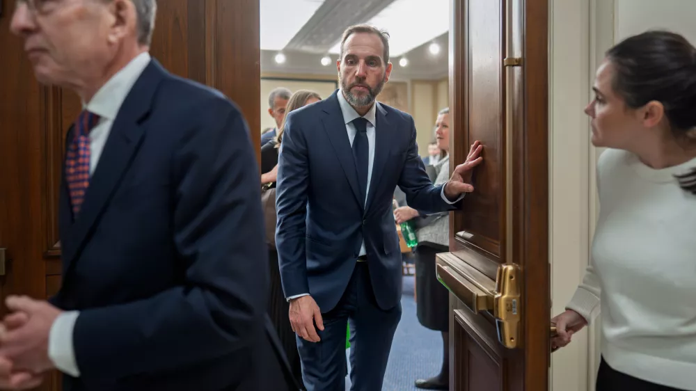 Former Department of Justice Special Counsel Jack Smith, center, and his attorney Lanny Breuer, left, depart at the end of a Republican-led deposition before the House Judiciary Committee as part of its oversight into DOJ investigations into President Donald Trump, on Capitol Hill in Washington, Wednesday, Dec. 17, 2025. (AP Photo/J. Scott Applewhite)