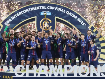 PSG's Marquinhos lifts the trophy after winning the FIFA Intercontinental Cup final soccer match between Flamengo and Paris Saint-Germain in Doha, Qatar, Wednesday, Dec. 17, 2025. (AP Photo/Hussein Sayed)