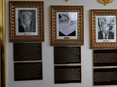 Portraits of U.S President Donald Trump flank an image of an autopen signing former U.S. President Joe Biden's signature in place of a portrait of Biden on the "Presidential Walk of Fame" along the White House Colonnade in Washington, D.C., U.S., December 17, 2025. REUTERS/Jessica Koscielniak