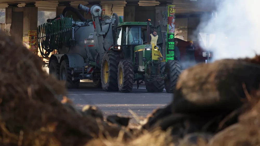 French farmers unload manure as they protest against the Mercosur trade deal with South American nations, Thursday, Dec. 18, 2025 in Portet-sur-Garonne, southwestern France. (AP Photo/Fred Scheiber)