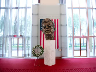 FILE - A memorial wreath stands next to the bronze memorial bust by Robert Berks of President John F. Kennedy in the grand foyer at the John F. Kennedy Center for the Performing Arts in Washington, Nov. 22, 2013, on the 50th anniversary of Kennedy's death. (AP Photo/Carolyn Kaster, File)