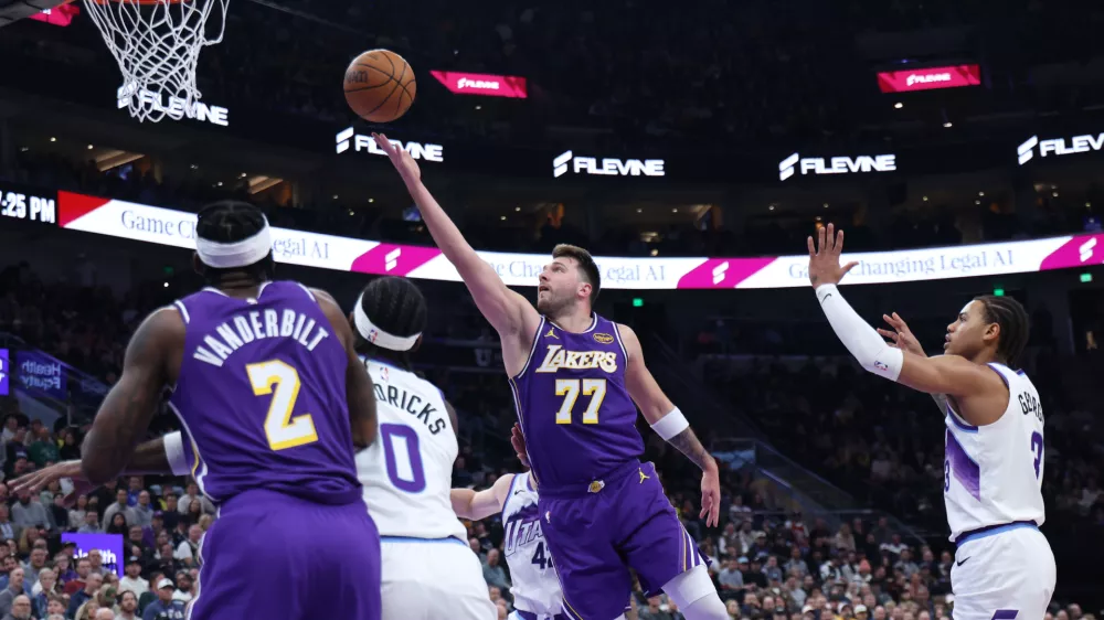 Los Angeles Lakers guard Luka Doncic (77) lays up the ball against the Utah Jazz during the first quarter of an NBA basketball game Thursday, Dec. 18, 2025, in Salt Lake City. (AP Photo/Rob Gray)