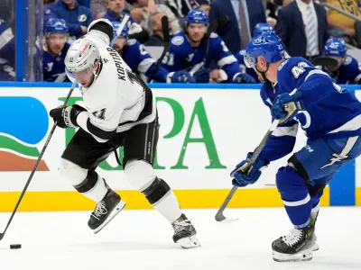 Los Angeles Kings center Anze Kopitar (11) beats Tampa Bay Lightning defenseman Darren Raddysh (43) up the ice during the third period of an NHL hockey game Thursday, Dec. 18, 2025, in Tampa, Fla. (AP Photo/Chris O'Meara)
