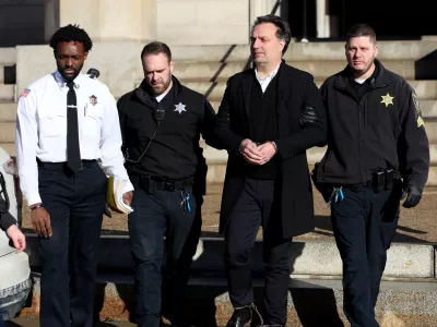 Brian Walshe is brought to a prisoner transport van after he was sentenced in Norfolk Superior Court in Dedham, Mass., on Thursday, Dec. 18, 2025. (Mark Stockwell/Boston Herald via AP, Pool)