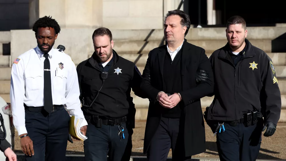 Brian Walshe is brought to a prisoner transport van after he was sentenced in Norfolk Superior Court in Dedham, Mass., on Thursday, Dec. 18, 2025. (Mark Stockwell/Boston Herald via AP, Pool)