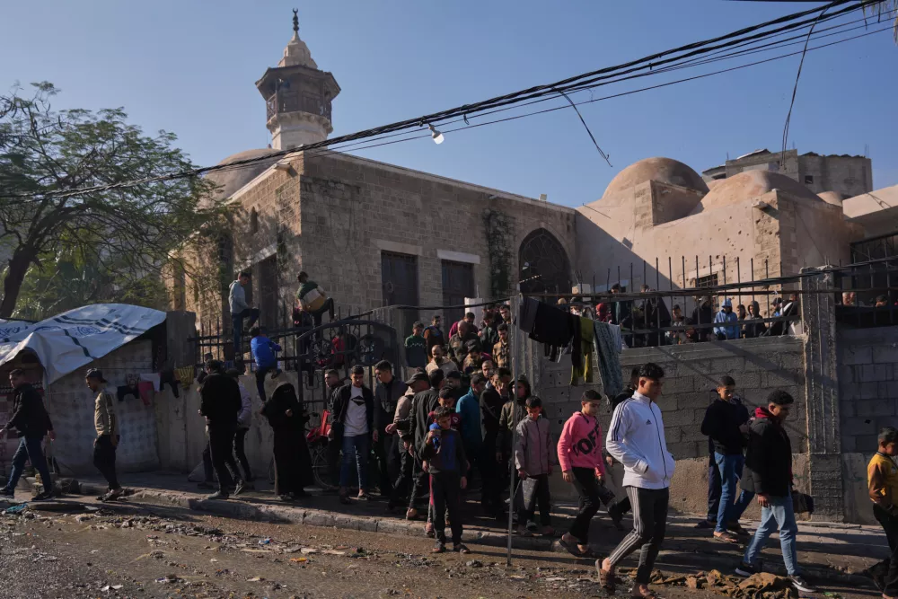 Palestinians leave the Sayyid Hashim Mosque after attending Friday prayers, in Gaza City, Friday, Dec. 19, 2025. (AP Photo/Abdel Kareem Hana)