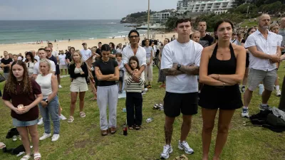People observe a moment of silence during the 'Light Over Darkness' vigil for victims and survivors of a deadly mass shooting during a Jewish Hanukkah celebration at Bondi Beach on December 14, in Sydney, Australia, December 21, 2025. REUTERS/Eloisa Lopez