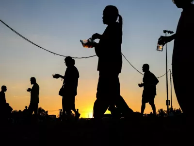 FILE PHOTO: Displaced people walk after receiving food at a temporary shelter amid clashes between Thailand and Cambodia along a disputed border area, in Buriram province, Thailand, December 16, 2025. REUTERS/Athit Perawongmetha/File Photo